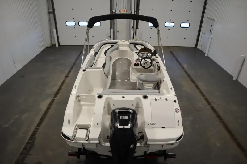 Slide: The Image of 2015 Starcraft 1915 OB Limited boat in indoor storage, featuring a 115 HP engine. - 10