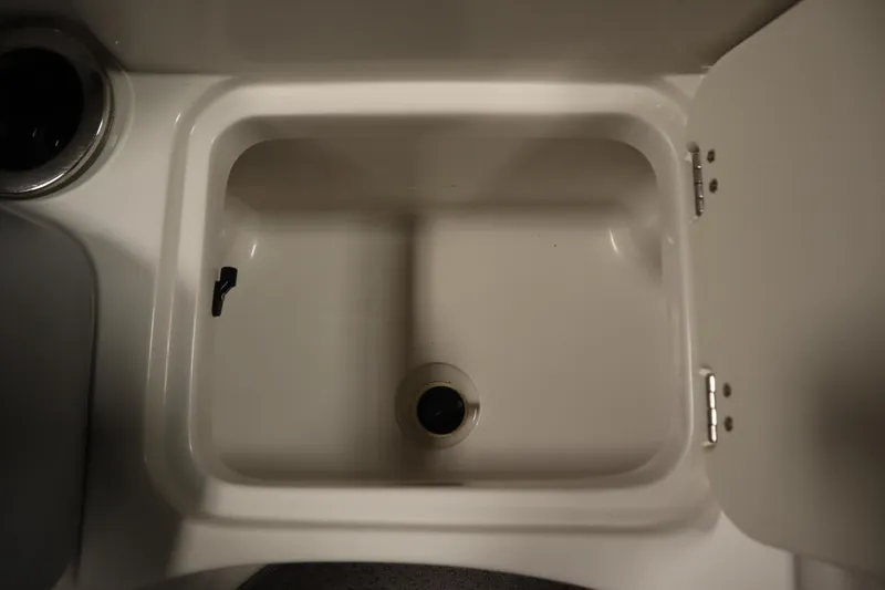 Slide: The Image of 2015 Starcraft 1915 OB Limited boat sink with open storage compartment. - 14