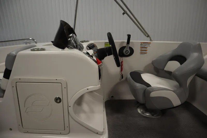 Slide: The Image of 2015 Starcraft 1915 OB Limited boat interior with steering wheel and captain's chair. - 19