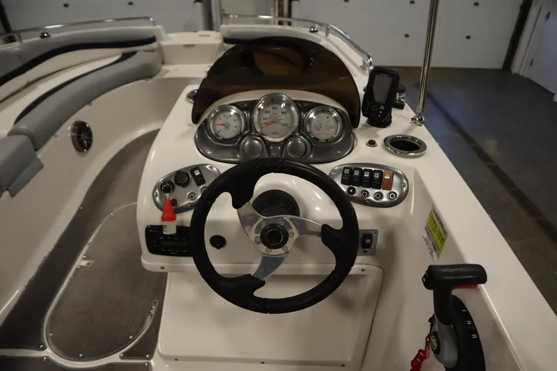 Slide: The Image of 2015 Starcraft 1915 OB Limited boat dashboard with steering wheel and control panel. - 21