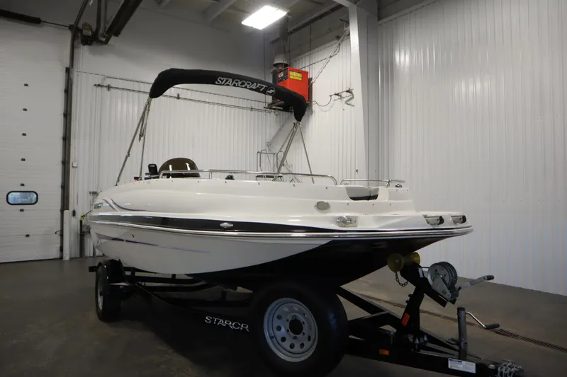 Slide: The Image of 2015 Starcraft 1915 OB Limited boat on trailer in indoor storage facility. - 3