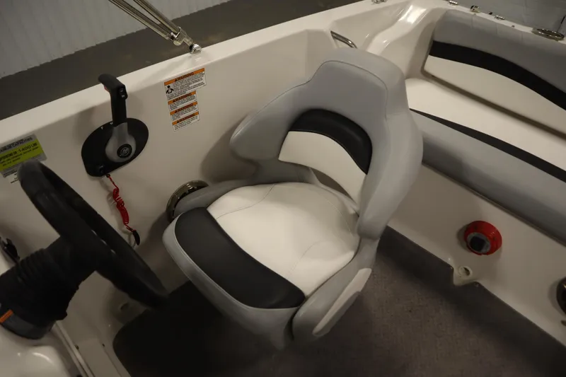 Slide: The Image of 2015 Starcraft 1915 OB Limited boat interior with steering wheel and seating. - 30