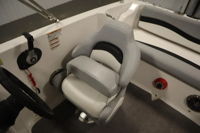 Slide: The Image of 2015 Starcraft 1915 OB Limited boat interior with steering wheel and cushioned seat. - 31