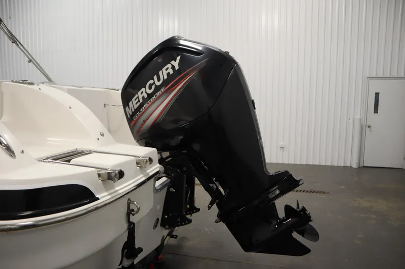 Slide: The Image of 2015 Starcraft 1915 OB Limited boat with Mercury FourStroke outboard motor in a garage. - 37