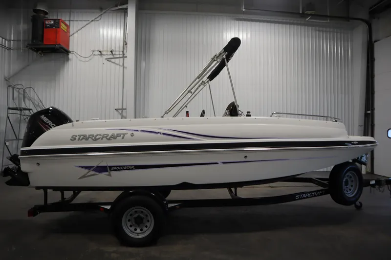 Slide: The Image of 2015 Starcraft 1915 OB Limited boat on trailer in indoor storage. - 4