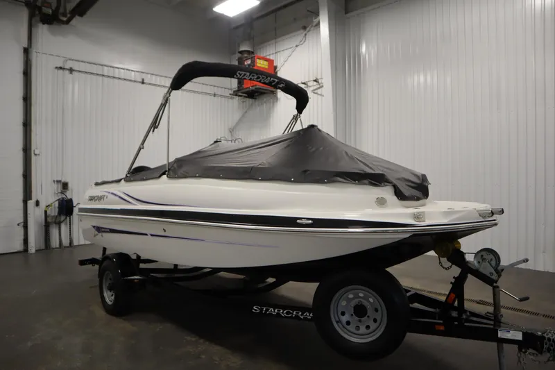 Slide: The Image of 2015 Starcraft 1915 OB Limited boat on trailer in indoor storage. - 44