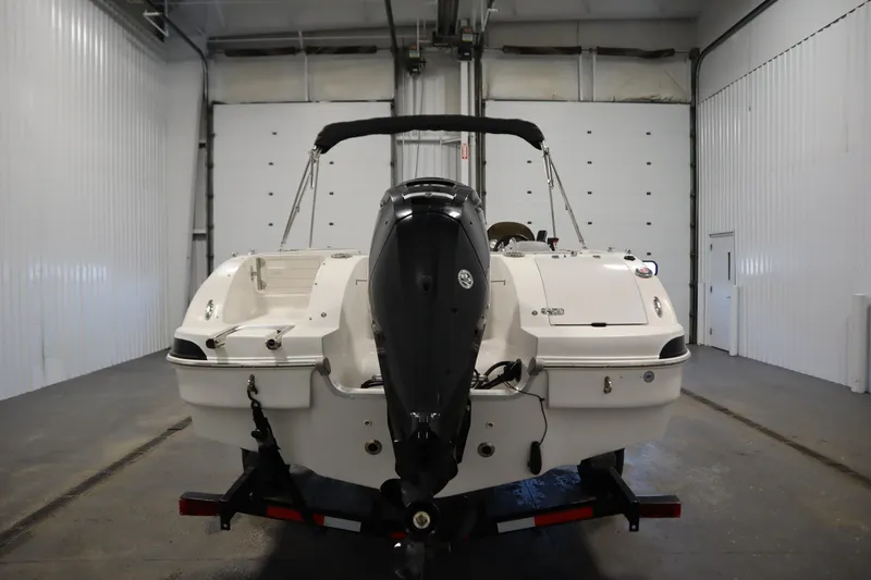 Slide: The Image of 2015 Starcraft 1915 OB Limited boat in a garage, rear view with outboard motor. - 6