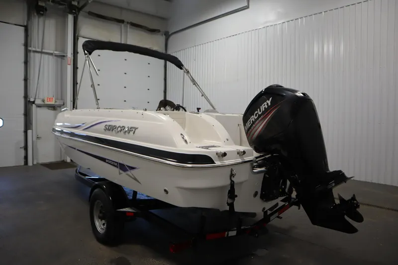 Slide: The Image of 2015 Starcraft 1915 OB Limited boat with Mercury outboard motor in indoor storage. - 7