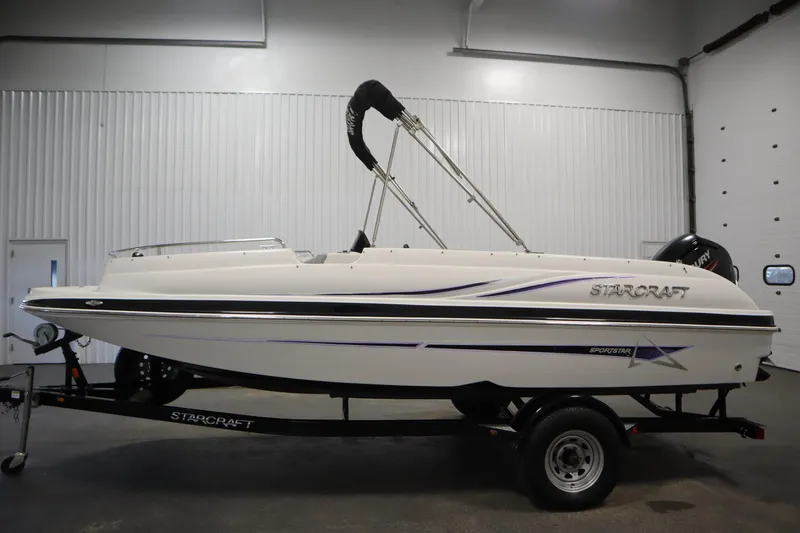 Slide: The Image of 2015 Starcraft 1915 OB Limited boat on trailer in indoor setting. - 8