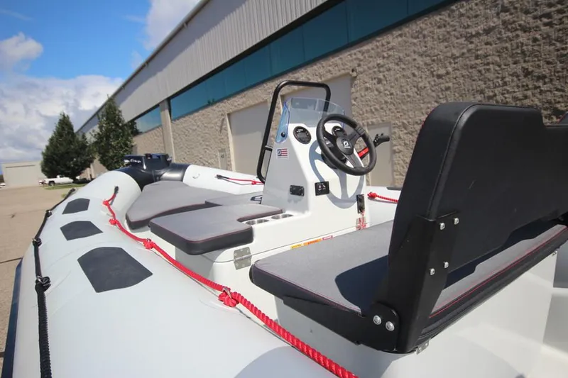 Slide: The Image of Zodiac Open 4.8 NEO 70hp boat, 2026 model, parked outdoors. - 7