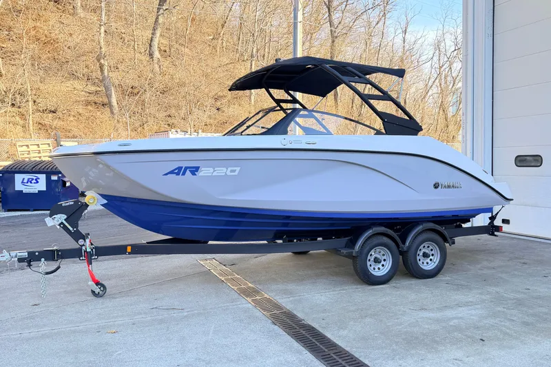The Image of 2026 Yamaha AR220 boat on trailer outdoors. - 0