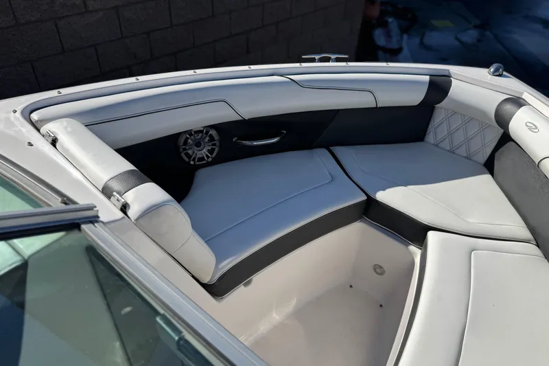 Slide: The Image of 2019 Regal 2100 boat interior with white and black seating, speaker, and stylish design. - 13