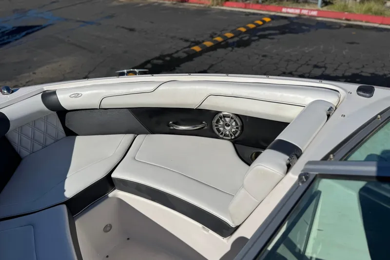 Slide: The Image of 2019 Regal 2100 boat interior with white leather seating and speaker detail. - 14