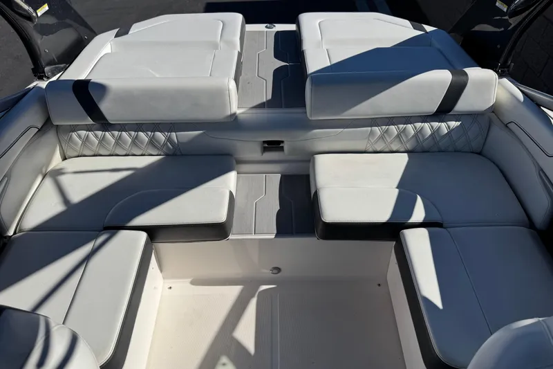 Slide: The Image of 2019 Regal 2100 boat interior with luxurious white seating and diamond stitching. - 16