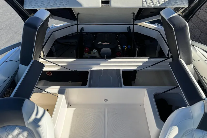 Slide: The Image of 2019 Regal 2100 boat interior with open engine compartment and seating. - 17