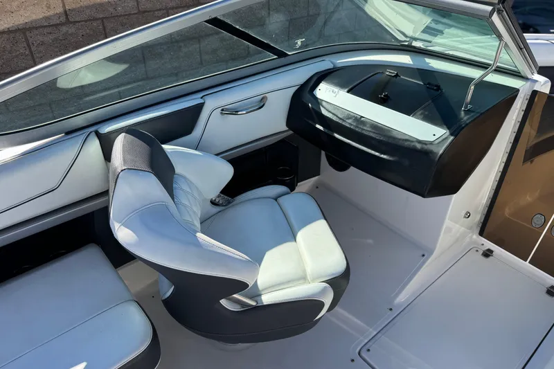 Slide: The Image of Interior of a 2019 Regal 2100 boat featuring a sleek captain's chair and dashboard. - 19