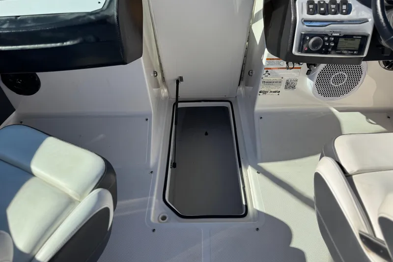 Slide: The Image of Interior of a 2019 Regal 2100 boat showing seating and control panel. - 21