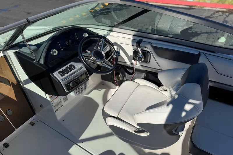 Slide: The Image of 2019 Regal 2100 boat interior with steering wheel and captain's seat. - 22