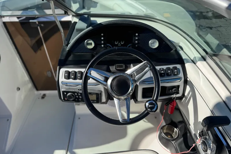 Slide: The Image of 2019 Regal 2100 boat dashboard with steering wheel and control panel. - 23