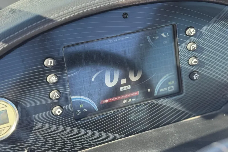 Slide: The Image of Dashboard of 2019 Regal 2100 boat showing digital speedometer and controls. - 25