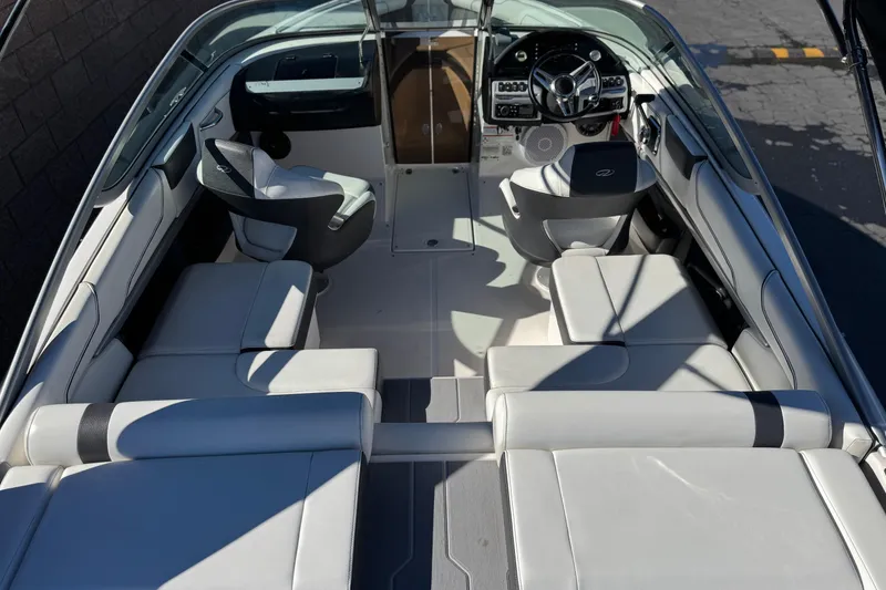 Slide: The Image of 2019 Regal 2100 boat interior with sleek seating and modern dashboard. - 9
