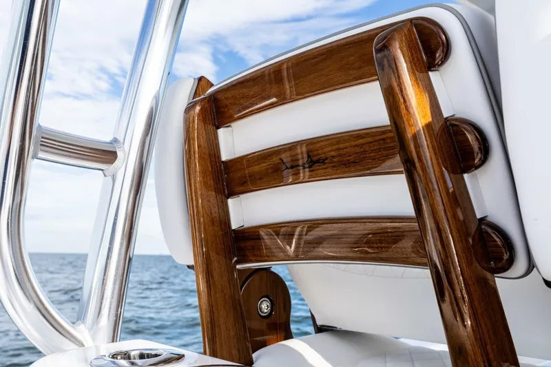 Slide: The Image of 2026 Valhalla Boatworks V-46, luxurious wooden seating detail, ocean backdrop. - 10