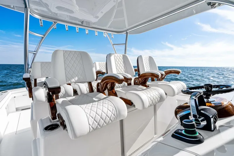 Slide: The Image of Luxurious 2026 Valhalla Boatworks V-46 interior with white quilted seats and ocean view. - 13