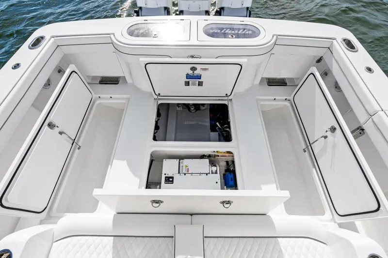 Slide: The Image of 2026 Valhalla Boatworks V-46 deck with open storage compartments and engine access. - 31