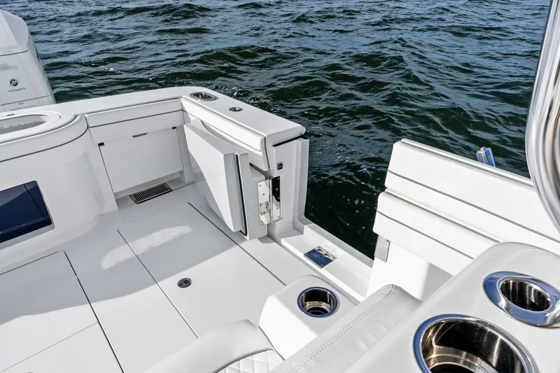 Slide: The Image of 2026 Valhalla Boatworks V-46 deck with seating and cup holders, overlooking water. - 32