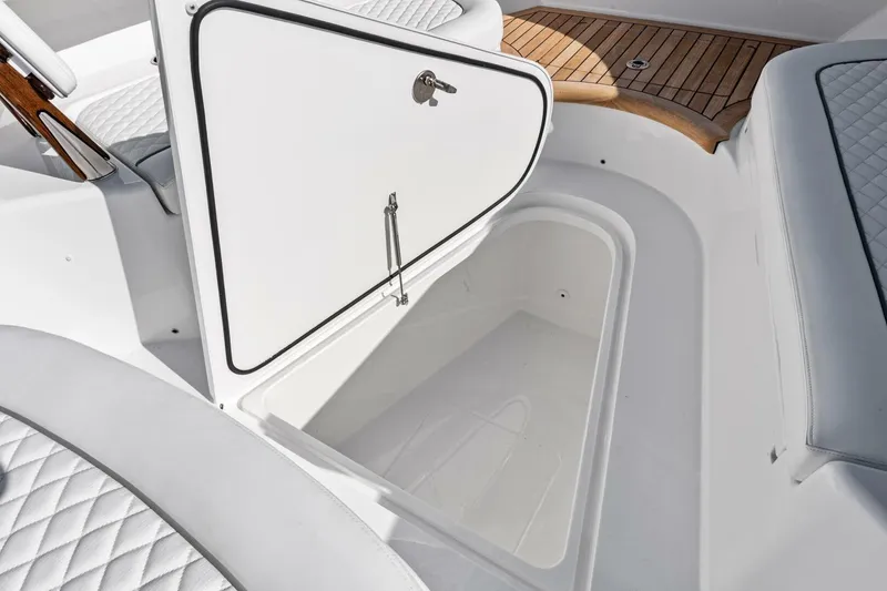 Slide: The Image of 2026 Valhalla Boatworks V-46 storage compartment with white interior and teak flooring. - 40