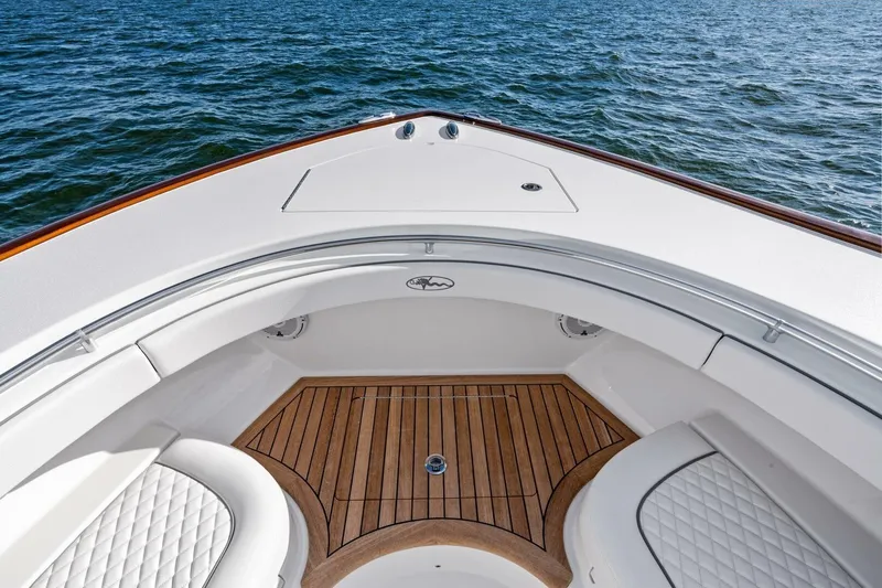 Slide: The Image of 2026 Valhalla Boatworks V-46 bow with teak flooring and cushioned seating on water. - 41