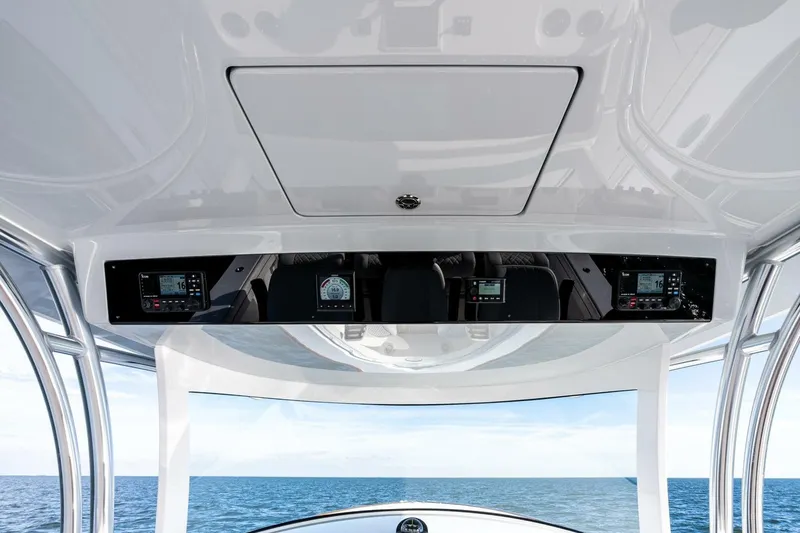 Slide: The Image of 2026 Valhalla Boatworks V-46 helm with advanced navigation displays, overlooking the ocean. - 46