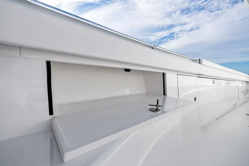 Slide: The Image of 2026 Valhalla Boatworks V-46 deck with sleek white storage compartments. - 56
