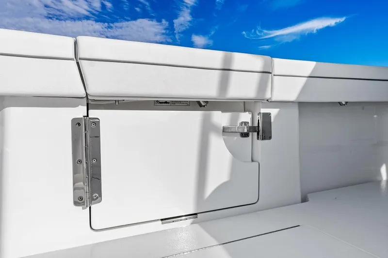 Slide: The Image of 2026 Valhalla Boatworks V-46 deck detail with storage compartment under clear blue sky. - 58