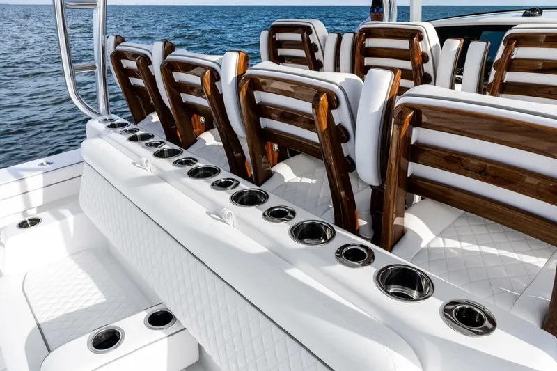 Slide: The Image of Luxury seating on 2026 Valhalla Boatworks V-46, featuring elegant wood and white upholstery. - 7