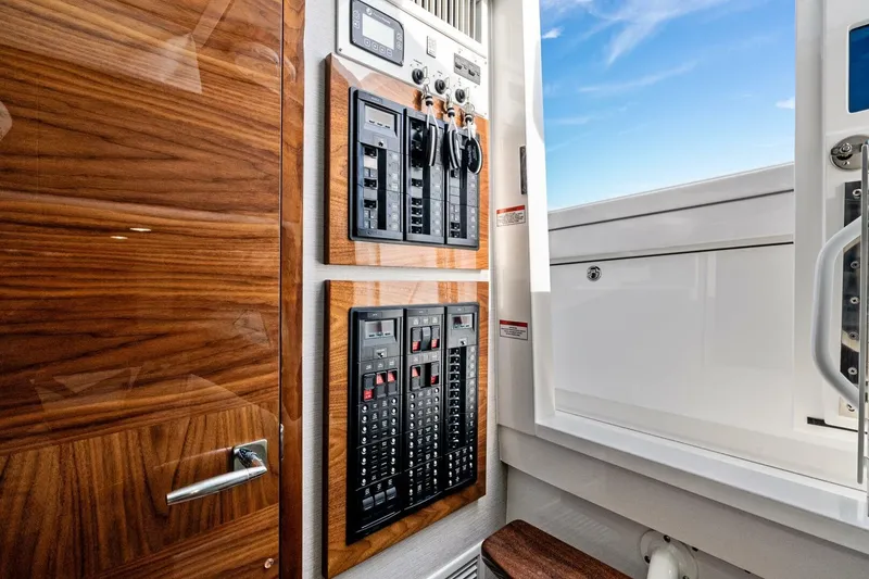 Slide: The Image of 2026 Valhalla Boatworks V-46 interior with control panels and wooden finish. - 70
