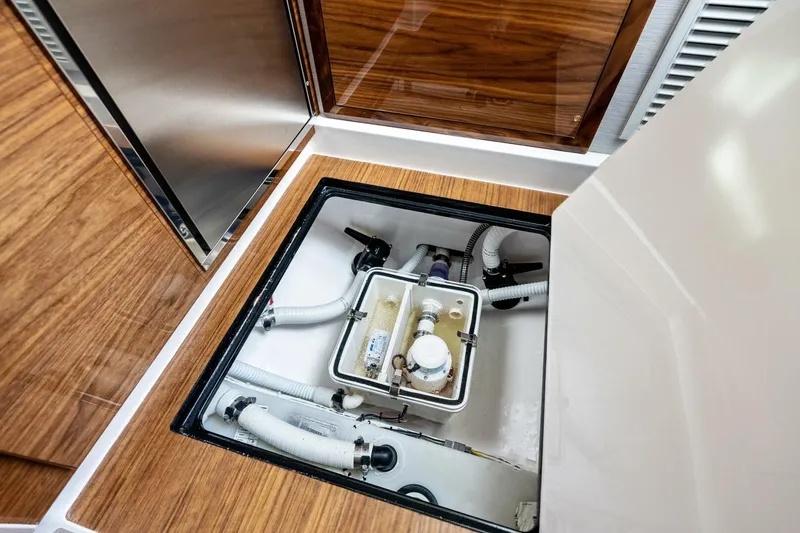 Slide: The Image of 2026 Valhalla Boatworks V-46 interior compartment with plumbing and storage access. - 71