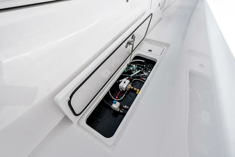 Slide: The Image of 2026 Valhalla Boatworks V-46 storage compartment with visible wiring and components. - 72
