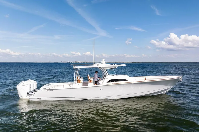 Slide: The Image of 2026 Valhalla Boatworks V-46 cruising on open water under a clear blue sky. - 74