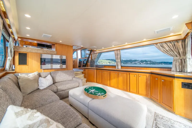 Slide: The Image of Luxurious interior of 1995 Tollycraft 57 Walk Around Pilothouse with panoramic windows and plush seating. - 12