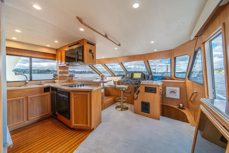 Slide: The Image of Luxurious 1995 Tollycraft 57 Walk Around Pilothouse interior with modern kitchen and helm. - 15