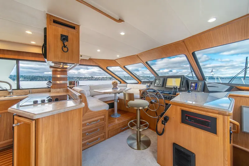 Slide: The Image of Luxurious 1995 Tollycraft 57 Walk Around Pilothouse interior with modern navigation equipment. - 16