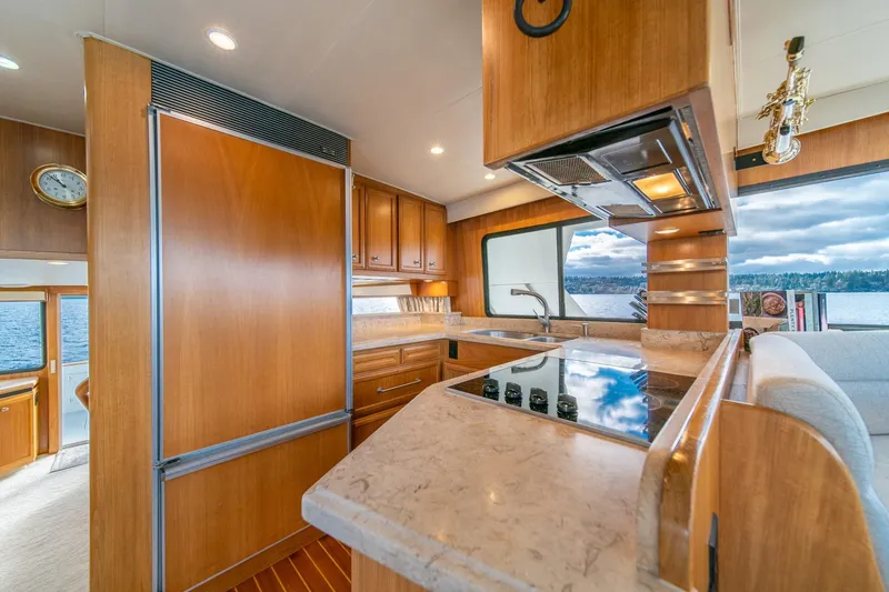 Slide: The Image of Luxurious 1995 Tollycraft 57 yacht kitchen with wood cabinetry and scenic water view. - 17