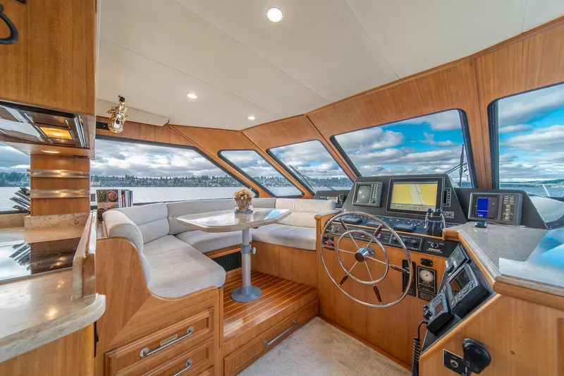 Slide: The Image of Luxurious 1995 Tollycraft 57 Walk Around Pilothouse interior with helm and seating area. - 18