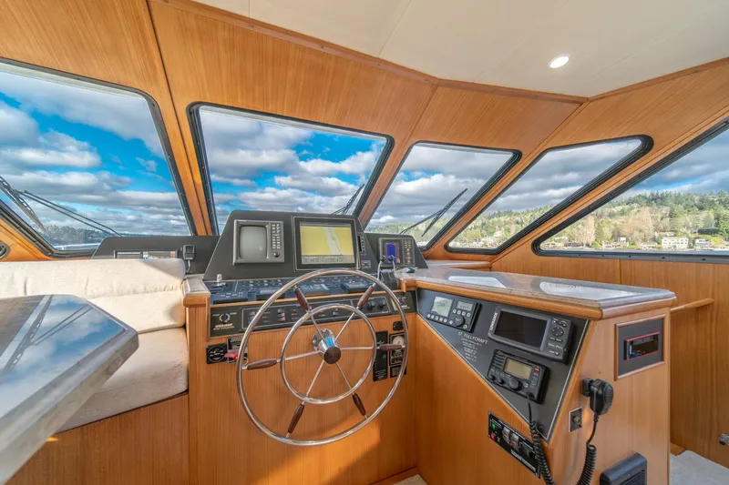 Slide: The Image of 1995 Tollycraft 57 Walk Around Pilothouse helm with navigation equipment and panoramic windows. - 19