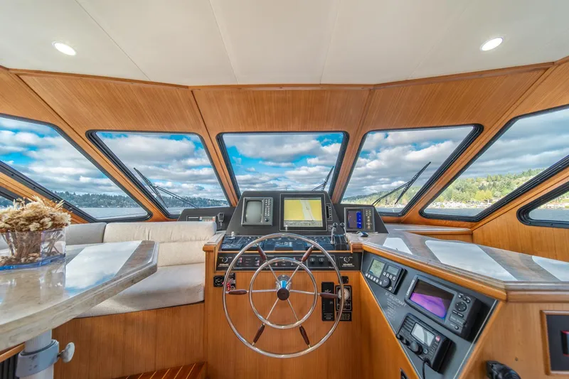 Slide: The Image of 1995 Tollycraft 57 Walk Around Pilothouse interior with helm, navigation equipment, and panoramic windows. - 21