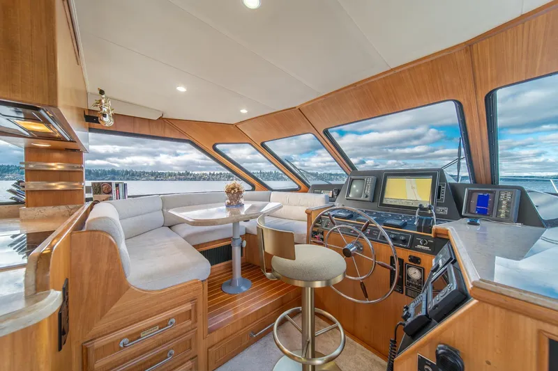Slide: The Image of Luxurious 1995 Tollycraft 57 Walk Around Pilothouse interior with panoramic windows and modern navigation. - 22