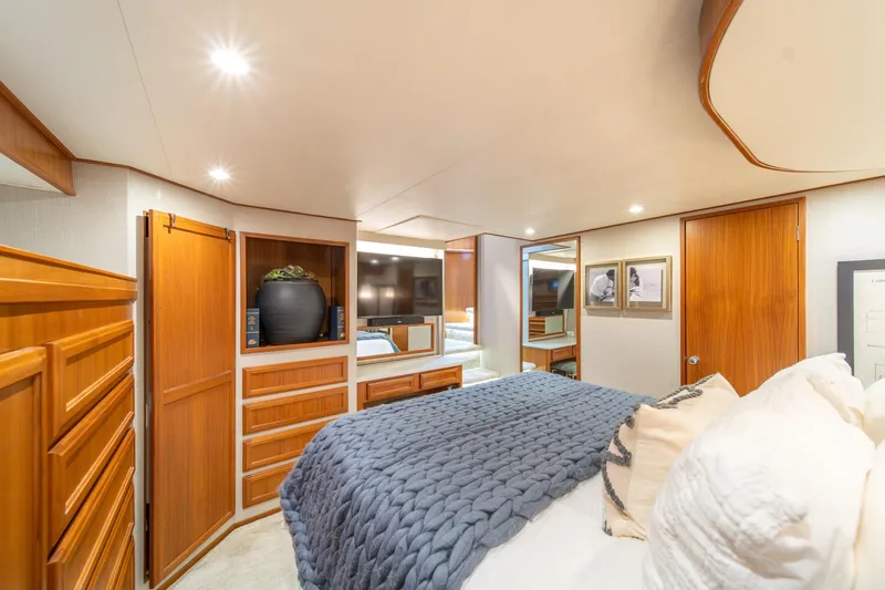 Slide: The Image of Luxurious 1995 Tollycraft 57 Walk Around Pilothouse bedroom with elegant wood cabinetry. - 23