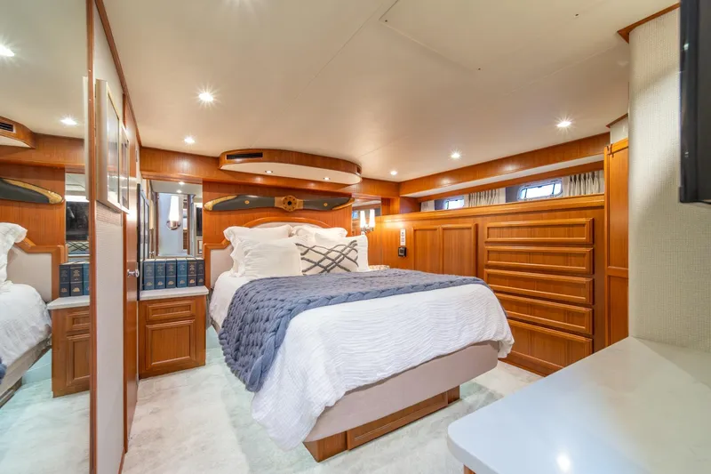 Slide: The Image of Luxurious bedroom interior of 1995 Tollycraft 57 Walk Around Pilothouse yacht with elegant wood finish. - 24