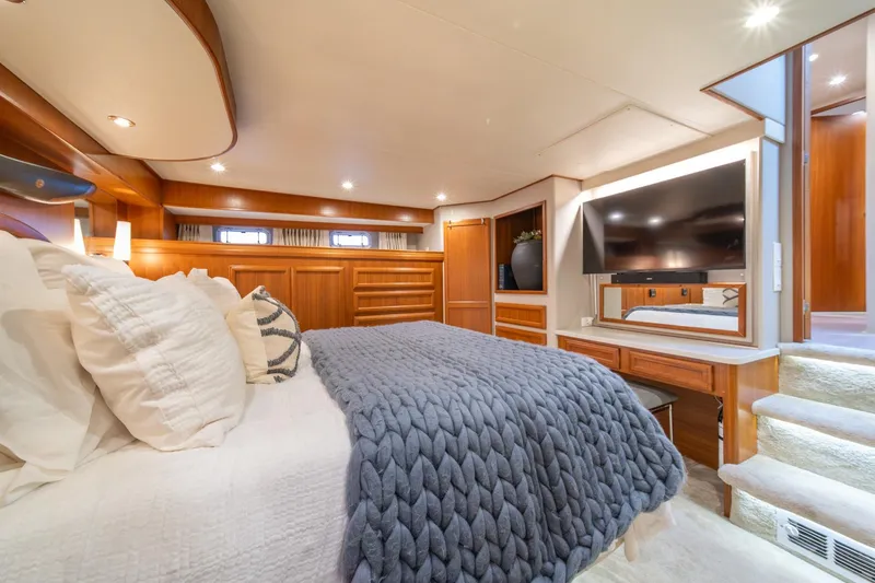 Slide: The Image of Luxurious bedroom in 1995 Tollycraft 57 Walk Around Pilothouse yacht, featuring elegant wood finishes. - 26